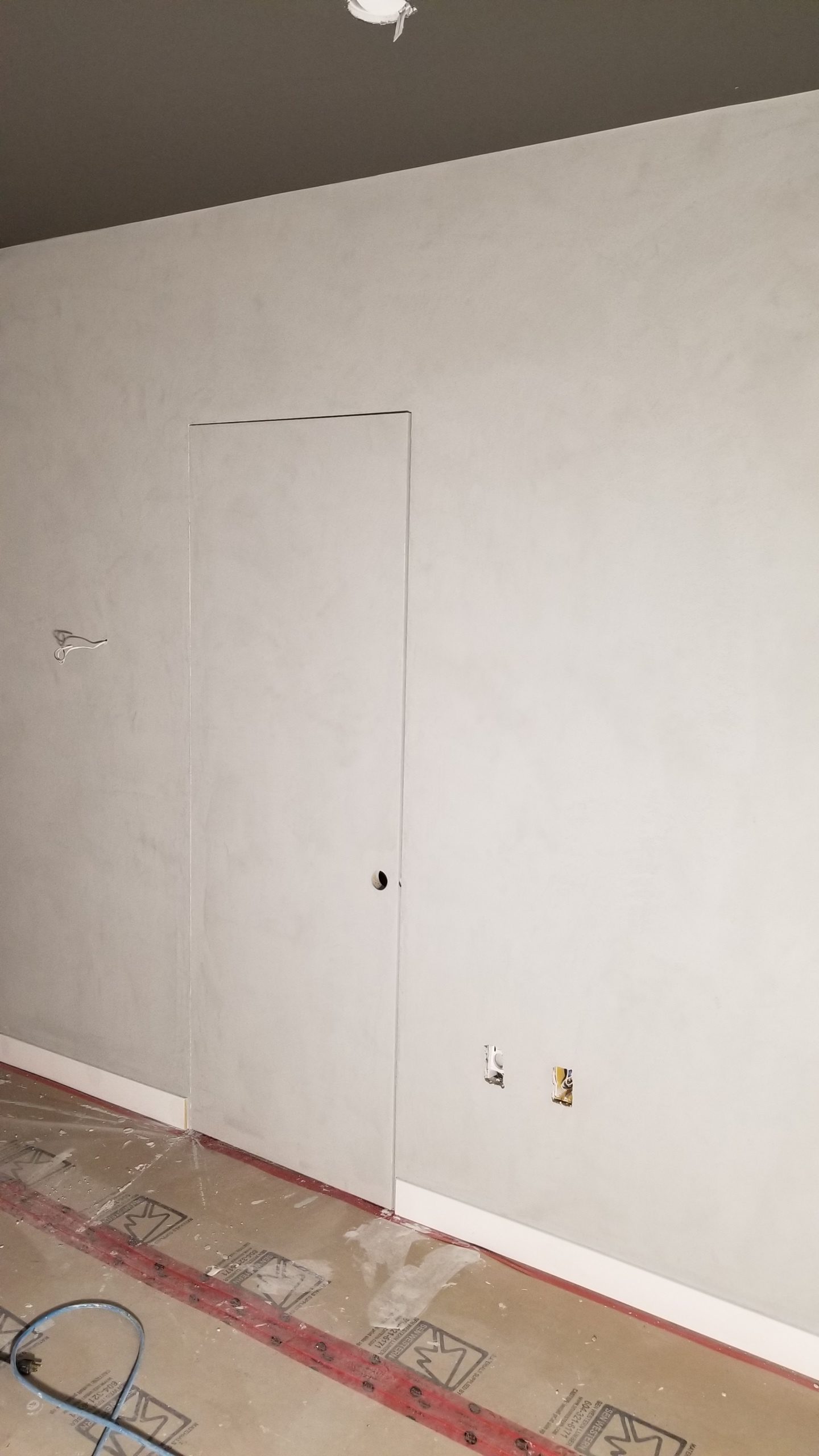 Concrete look walls for Entertainment Room. Plaster